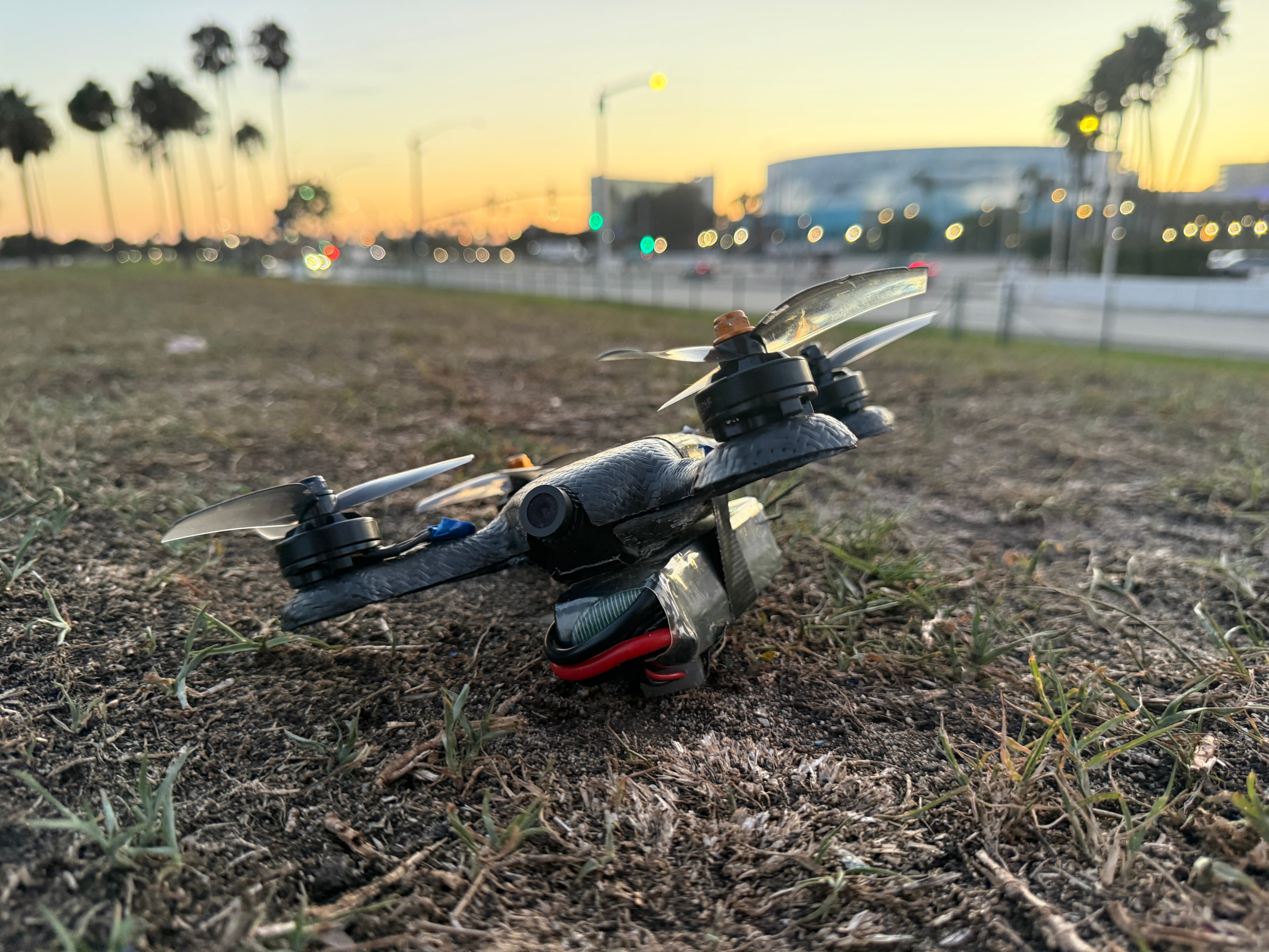 FPV drone in a field at sunset